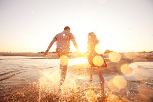 A loving couple sharing a sunset together while at the beach