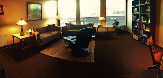 Dr. Schwab's warm, inviting office with couches, reclining chair and therapeutic items
